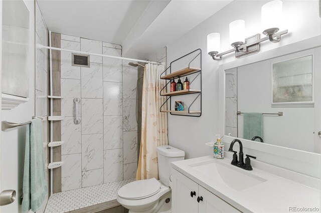 bathroom featuring a shower with curtain, vanity, and toilet