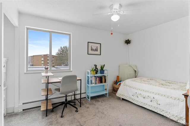 carpeted bedroom with ceiling fan, a textured ceiling, and a baseboard radiator