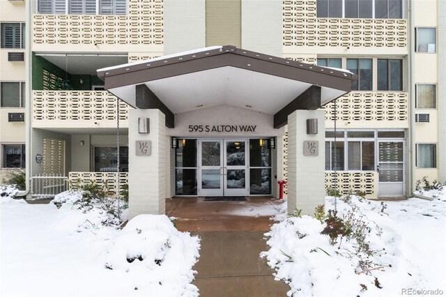 view of snow covered property entrance