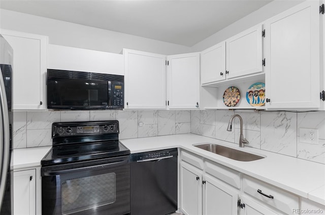 kitchen with a sink, decorative backsplash, black appliances, light countertops, and white cabinets