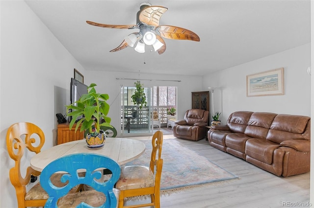 living room featuring ceiling fan and wood finished floors