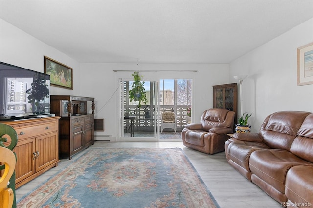 living room with a baseboard radiator and light wood-style floors