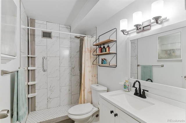 bathroom with a stall shower, vanity, toilet, and visible vents