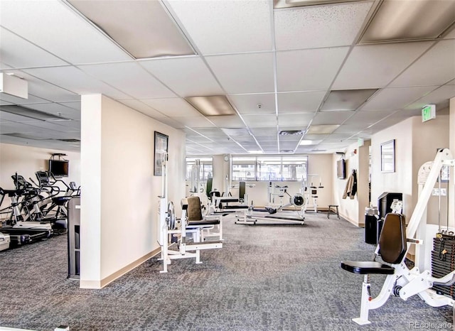 gym featuring a paneled ceiling, visible vents, baseboards, and carpet floors