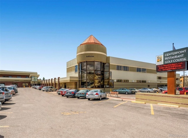 view of building exterior with uncovered parking