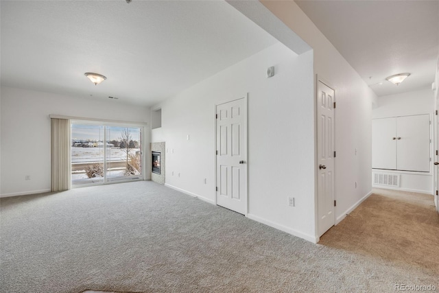 unfurnished living room featuring light colored carpet