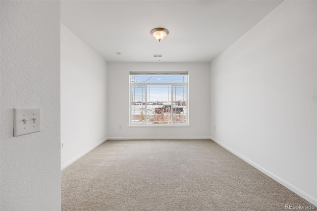 unfurnished room featuring carpet flooring