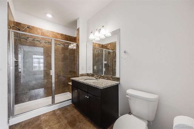 bathroom with vanity, toilet, and walk in shower