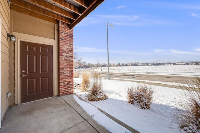 view of snow covered property entrance