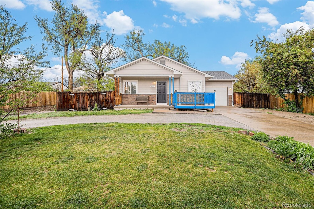 3065 W 80th Ave, Westminster, CO 80030 - view of front of property with driveway, covered porch, an attached garage, and brick siding