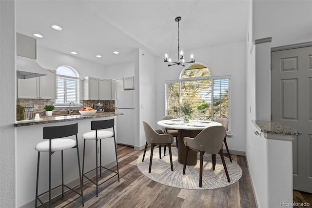 8422 S Upham Way Unit G60, Littleton, CO 80128 - dining area featuring dark wood-type flooring, recessed lighting, a chandelier, and baseboards