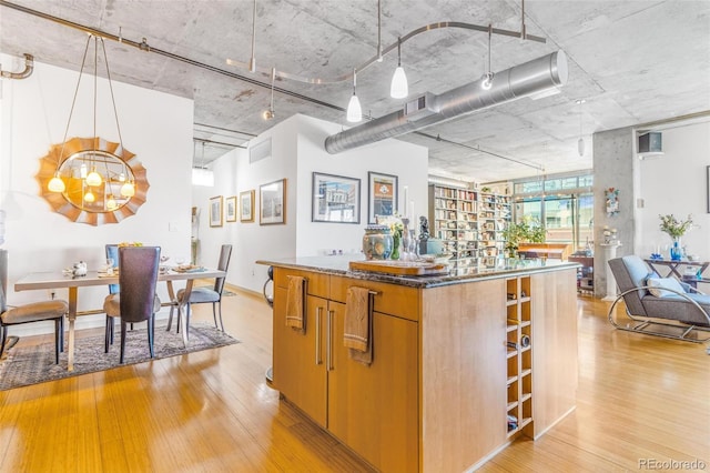 1401 Wewatta St Unit 806, Denver, CO 80202 - kitchen with light wood-style floors, a center island, and a chandelier