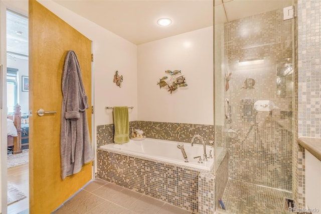1401 Wewatta St Unit 806, Denver, CO 80202 - full bathroom featuring a bath, ensuite bathroom, a stall shower, and tile patterned flooring