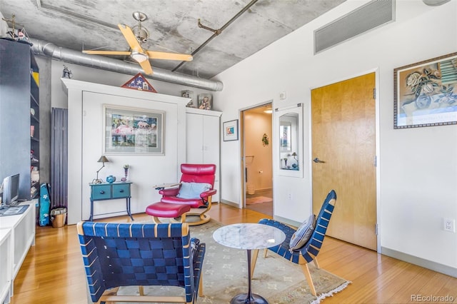 1401 Wewatta St Unit 806, Denver, CO 80202 - sitting room with wood finished floors and ceiling fan