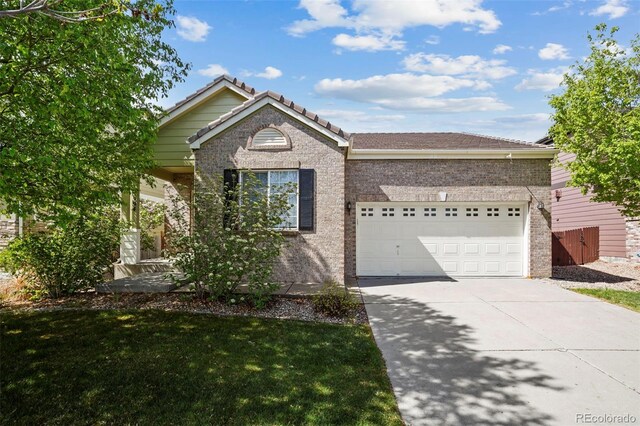 15594 E 97th Ave, Commerce City, CO 80022 - ranch-style home with brick siding, a garage, a front yard, and concrete driveway