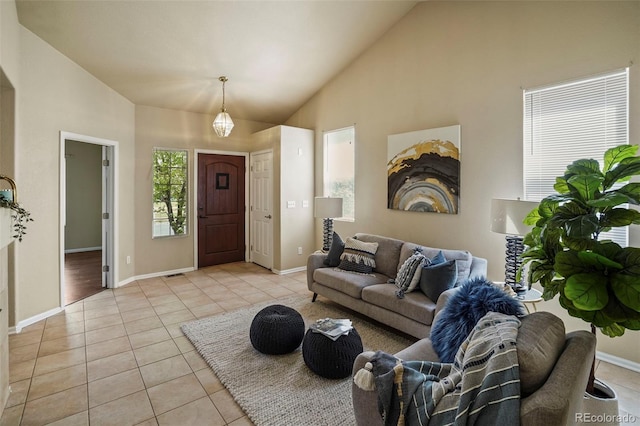 15594 E 97th Ave, Commerce City, CO 80022 - living room featuring baseboards, high vaulted ceiling, and light tile patterned flooring