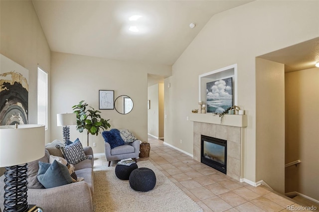 15594 E 97th Ave, Commerce City, CO 80022 - living room featuring baseboards, light tile patterned floors, vaulted ceiling, and a fireplace