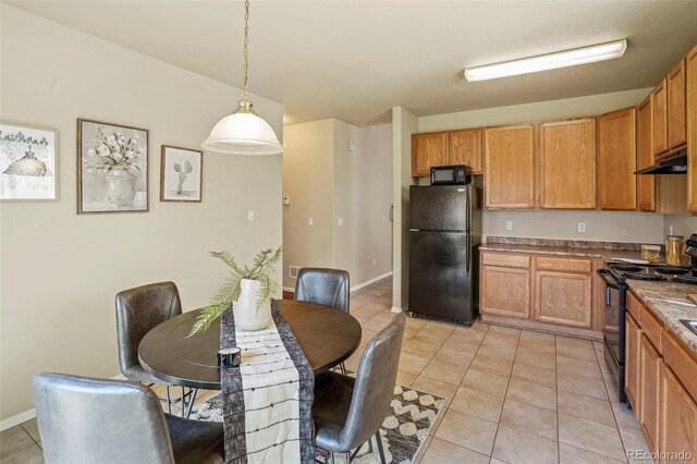 15594 E 97th Ave, Commerce City, CO 80022 - kitchen with baseboards, pendant lighting, light tile patterned floors, and black appliances