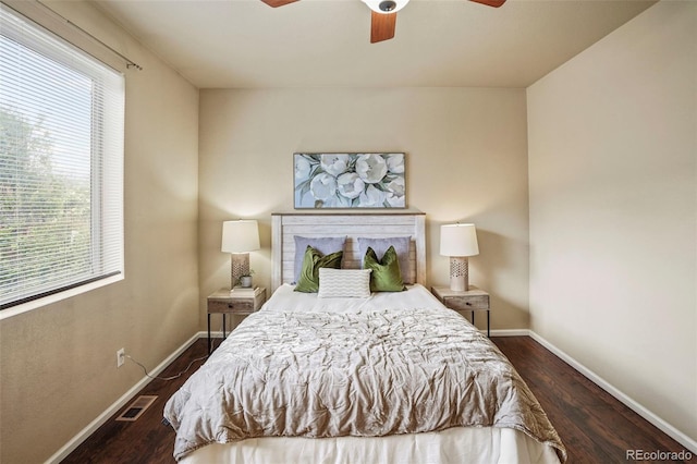 15594 E 97th Ave, Commerce City, CO 80022 - bedroom featuring baseboards, multiple windows, dark wood-style flooring, and visible vents
