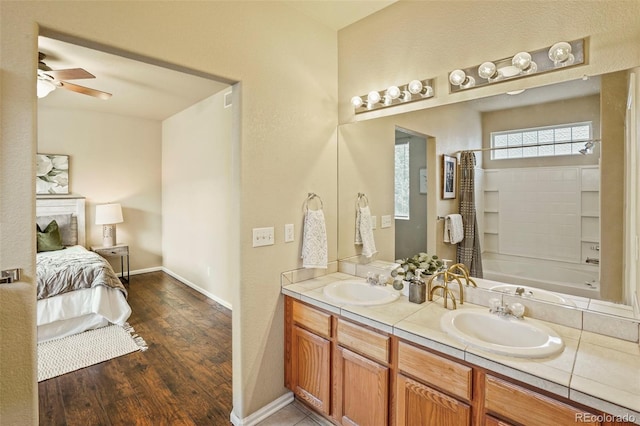 15594 E 97th Ave, Commerce City, CO 80022 - bathroom with a sink, double vanity, a ceiling fan, and wood finished floors