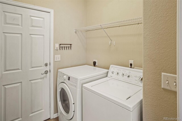 15594 E 97th Ave, Commerce City, CO 80022 - laundry area featuring separate washer and dryer, laundry area, and a textured wall