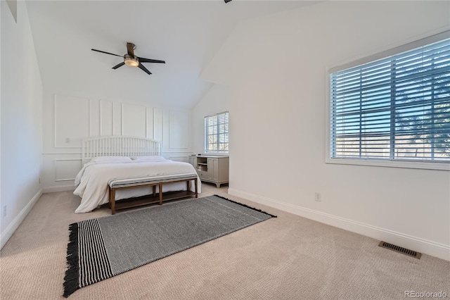 bedroom featuring lofted ceiling, light carpet, and ceiling fan