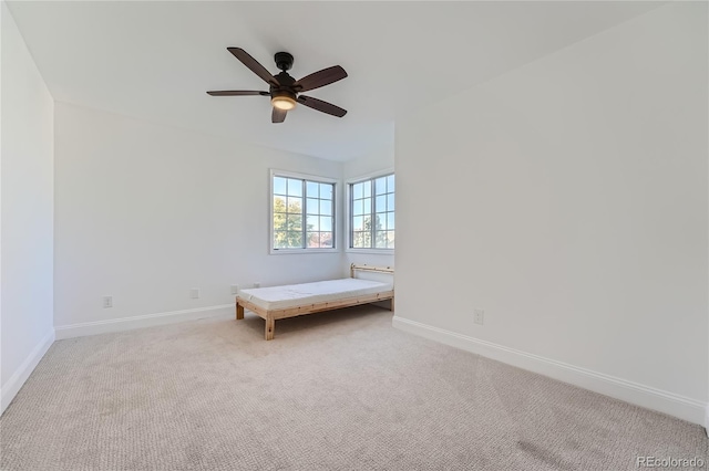 unfurnished bedroom with ceiling fan and light colored carpet