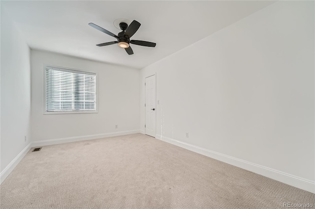 spare room with light carpet and ceiling fan