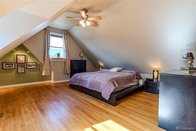 bedroom with light wood-type flooring, ceiling fan, and lofted ceiling