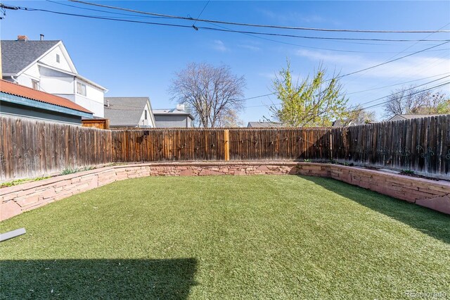view of yard with a fenced backyard