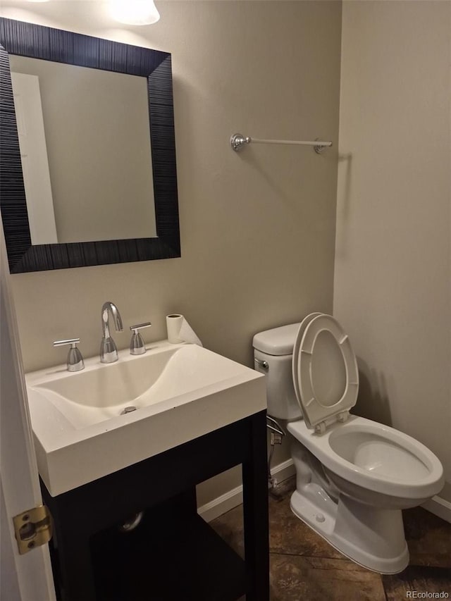 2238 S Nile Ct, Aurora, CO 80014 - half bath with baseboards, toilet, and vanity