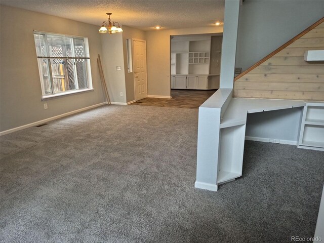 2238 S Nile Ct, Aurora, CO 80014 - unfurnished living room featuring carpet, a chandelier, a textured ceiling, and baseboards