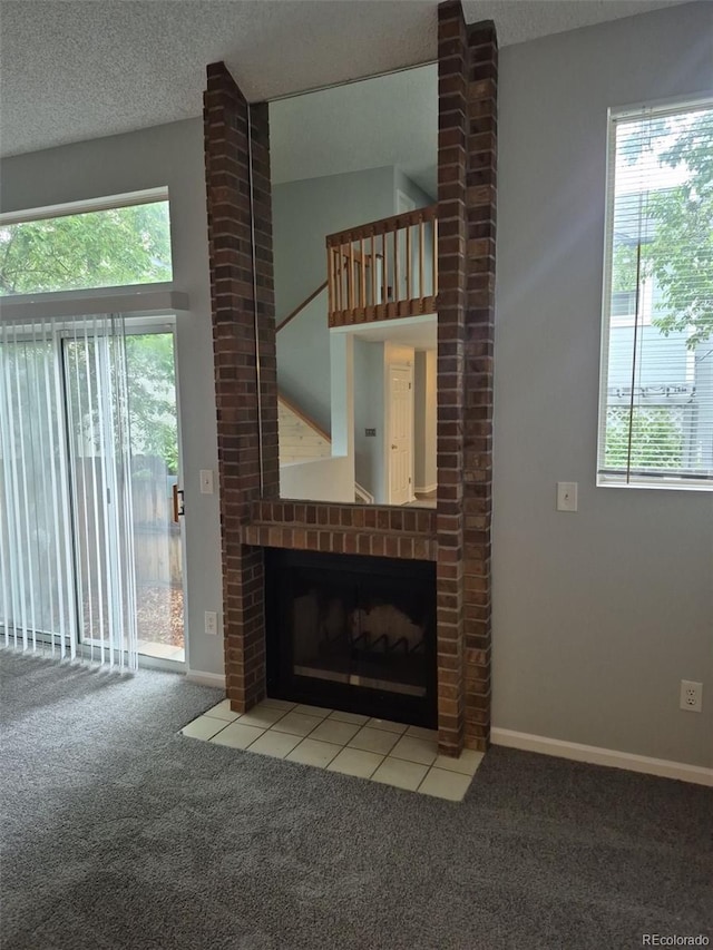 2238 S Nile Ct, Aurora, CO 80014 - unfurnished living room featuring carpet floors, a brick fireplace, and baseboards
