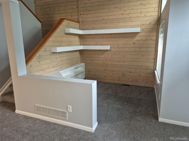 2238 S Nile Ct, Aurora, CO 80014 - unfurnished room with carpet floors, wooden walls, and stairs