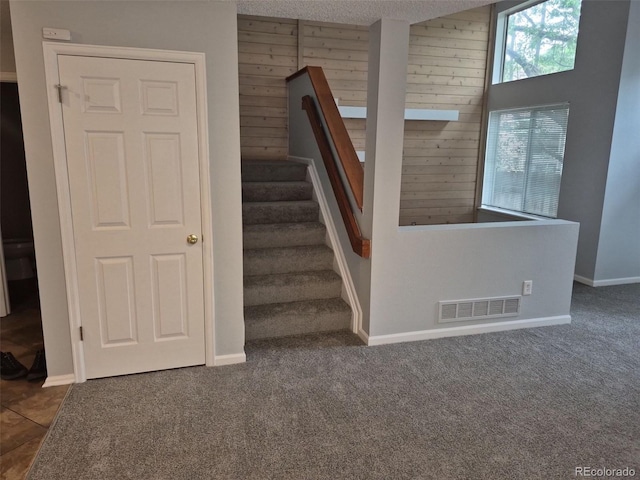 2238 S Nile Ct, Aurora, CO 80014 - stairway with carpet floors, baseboards, and wood walls