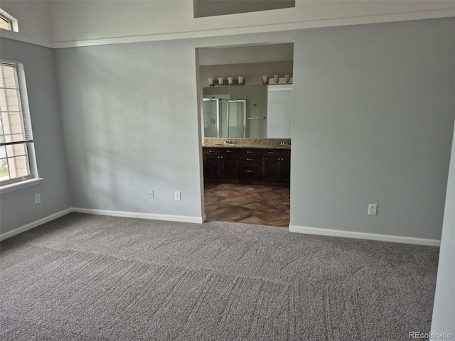 2238 S Nile Ct, Aurora, CO 80014 - spare room with dark colored carpet, baseboards, and a sink