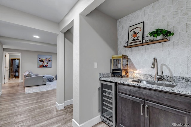 4840 Point Mesa St, Castle Rock, CO 80108 - indoor bar featuring beverage cooler, baseboards, light wood-type flooring, an accent wall, and recessed lighting