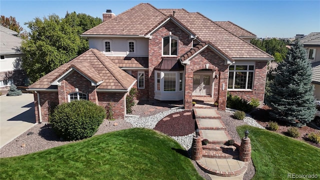 view of front of property featuring a front yard and french doors