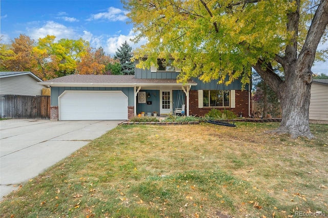 view of front of property with a front lawn and a garage