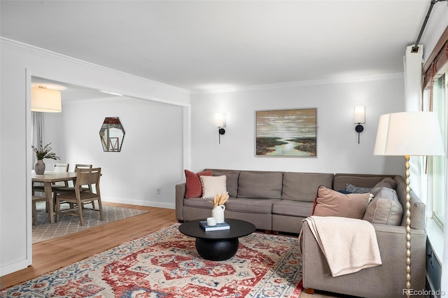 living room featuring hardwood / wood-style floors and crown molding