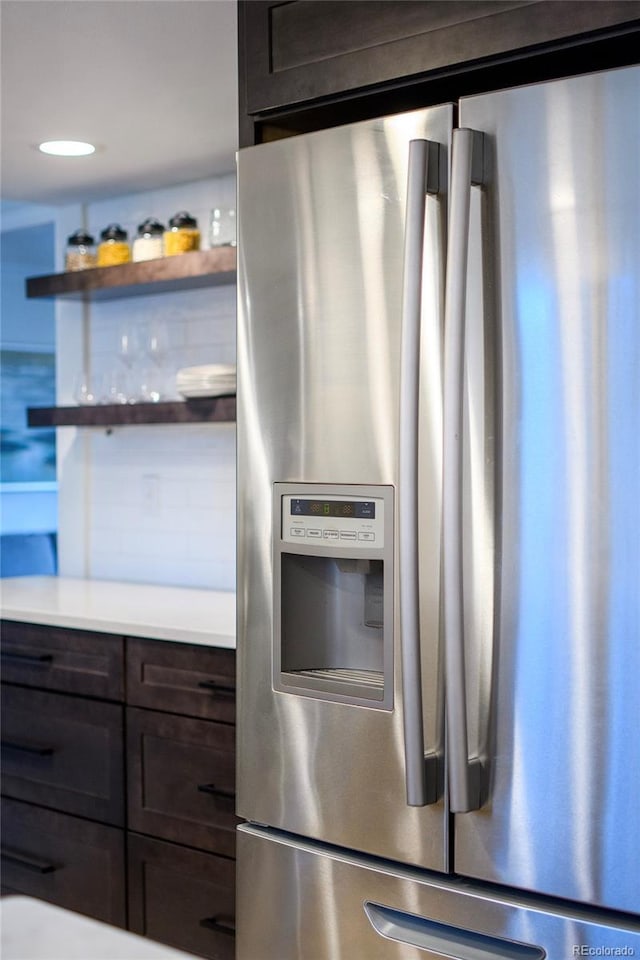 kitchen with dark brown cabinetry and stainless steel fridge with ice dispenser