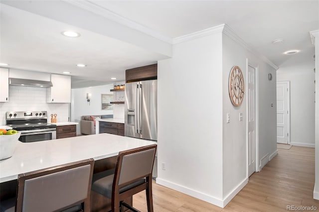 kitchen featuring white cabinets, light wood-type flooring, dark brown cabinetry, and stainless steel appliances