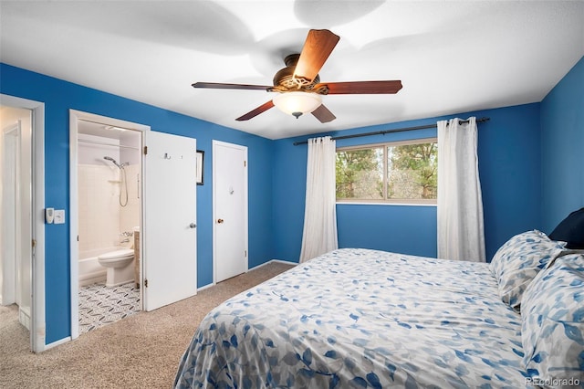 bedroom with light carpet, ensuite bathroom, and ceiling fan