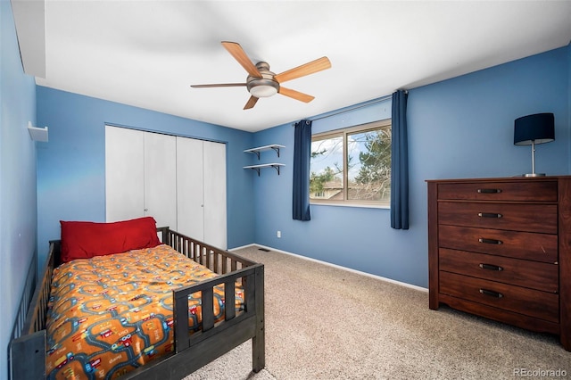 bedroom featuring ceiling fan, a closet, and carpet floors