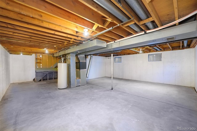 basement featuring gas water heater and heating unit