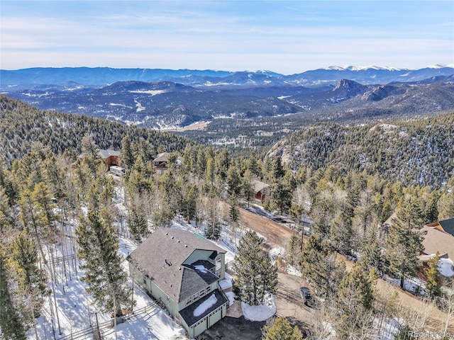 drone / aerial view featuring a mountain view and a forest view