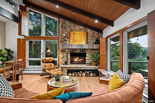 3 Twilight Dr, Wheat Ridge, CO 80215 - living area with a wooden ceiling with exposed beams, wood finished floors, plenty of natural light, a fireplace, and high vaulted ceiling