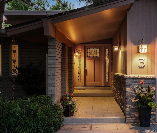 3 Twilight Dr, Wheat Ridge, CO 80215 - property entrance with brick siding, covered porch, and stone siding