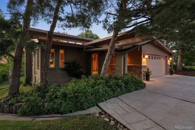 3 Twilight Dr, Wheat Ridge, CO 80215 - view of front of house with a garage, driveway, and brick siding