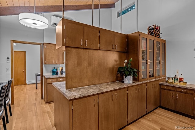 3 Twilight Dr, Wheat Ridge, CO 80215 - kitchen with light wood-style flooring, a wooden ceiling with exposed beams, brown cabinets, stove, and high vaulted ceiling